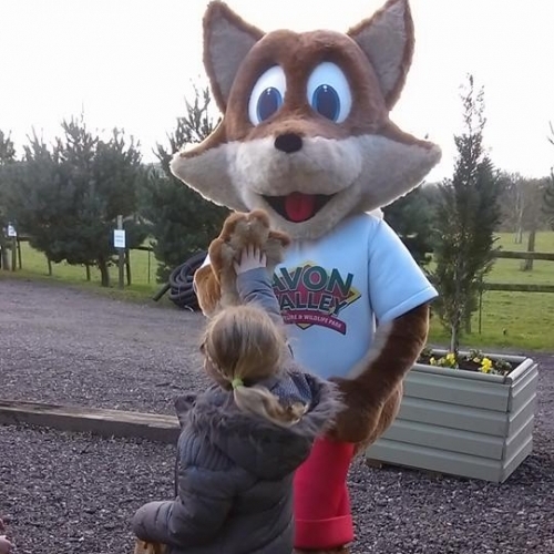 Felix the Fox high-fives young visitor